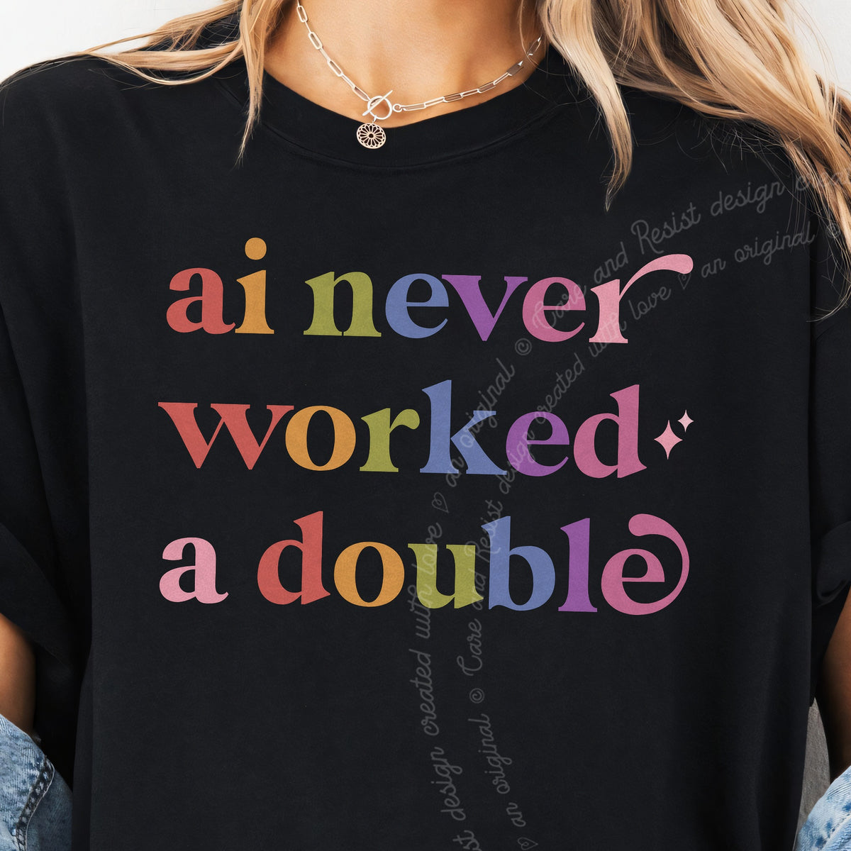 Ai Never Worked a Double Care & Resist tee in Black, close-up of the lettering