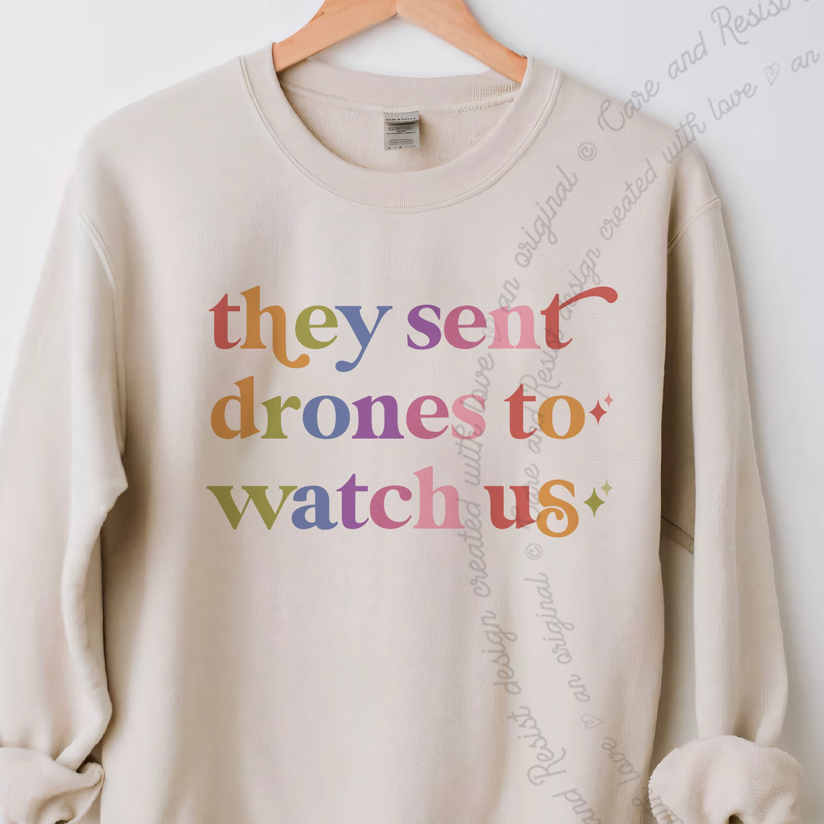 They Sent Drones to Watch Us Care & Resist Gildan crewneck sweatshirt in Sand