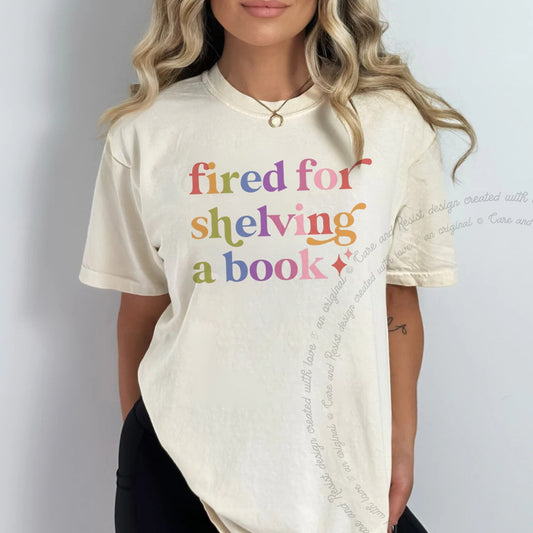 Fired for Shelving a Book Care & Resist rainbow tee