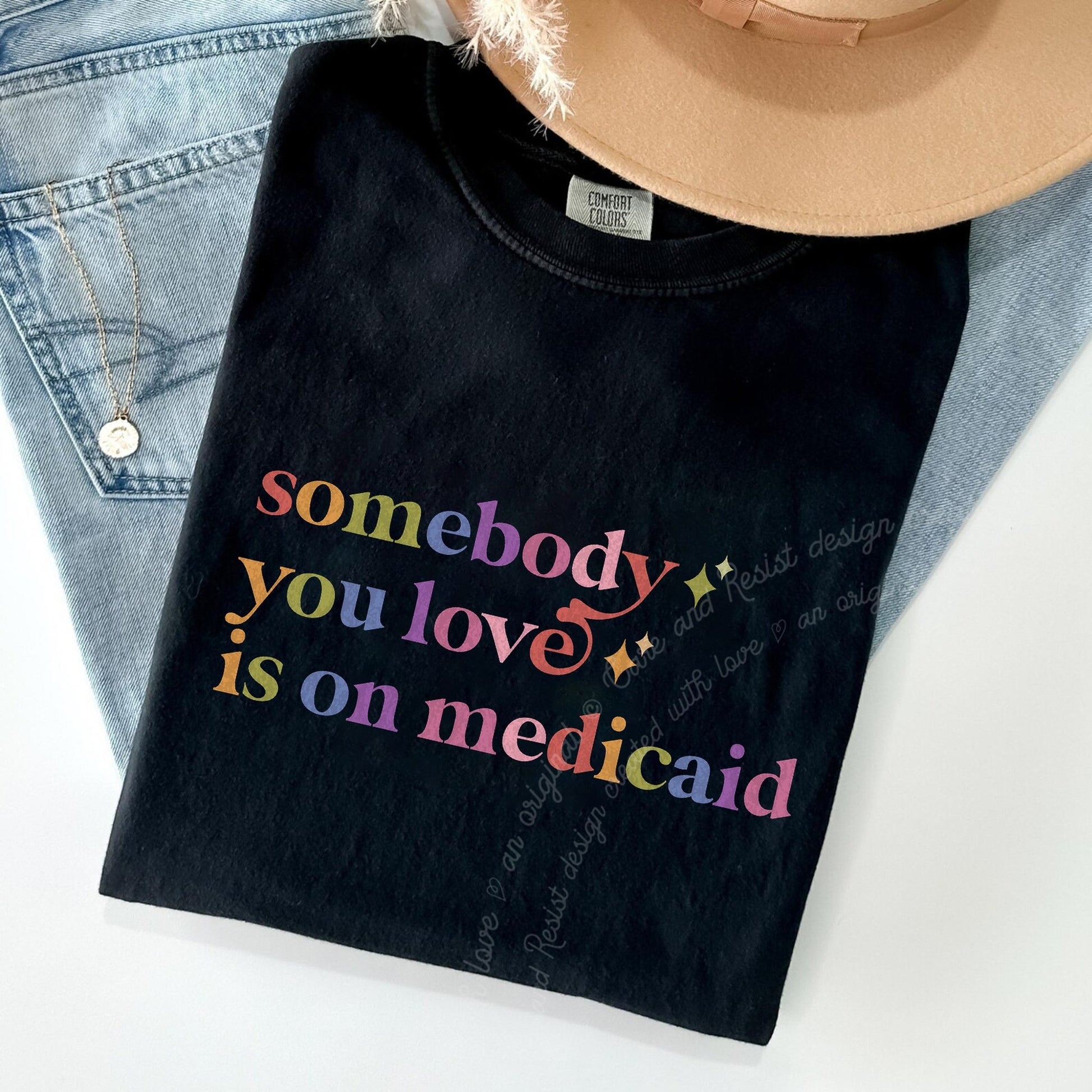 Somebody You Love is on Medicaid Care & Resist rainbow Comfort Colors tee, Black