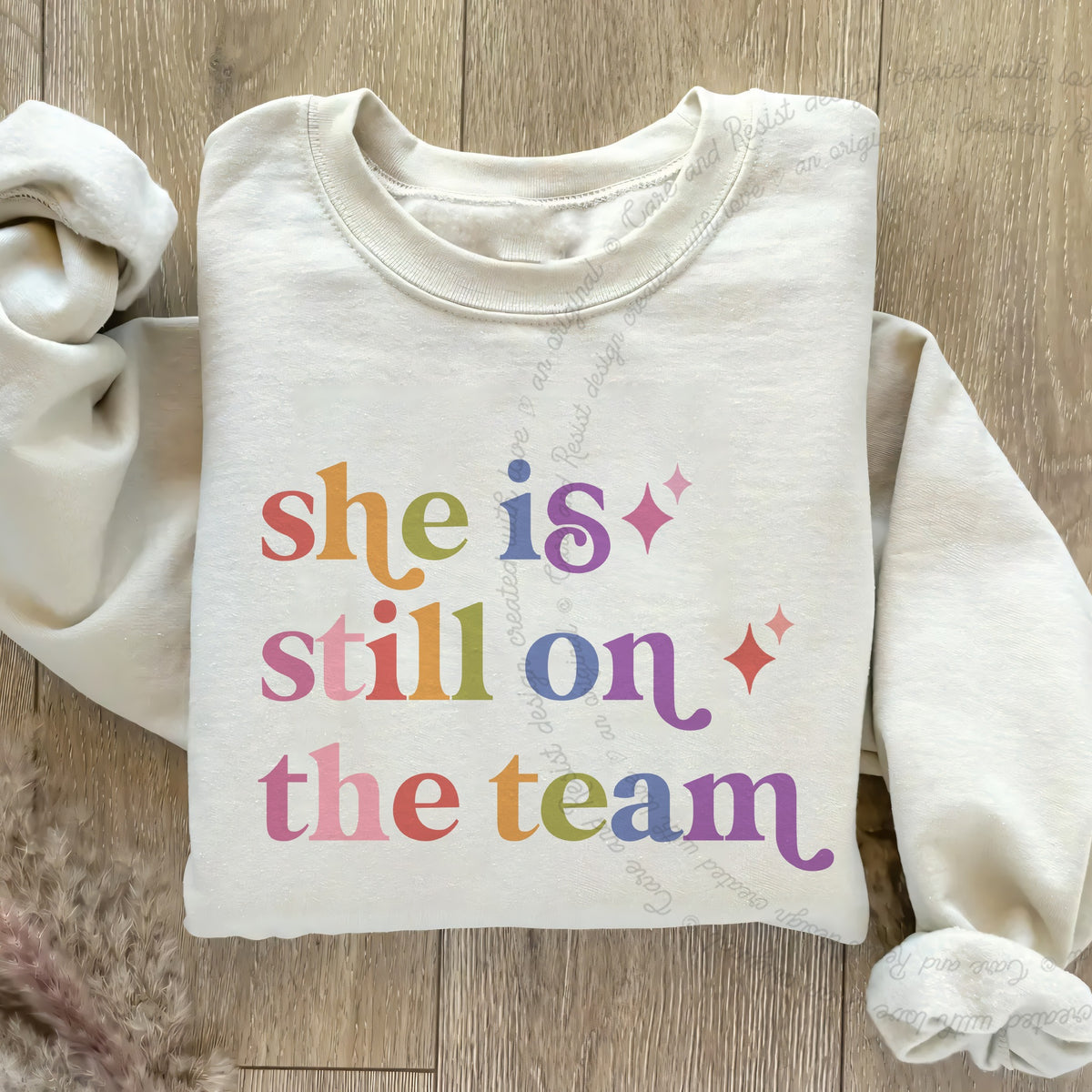She is Still on the Team Care & Resist Gildan crewneck sweatshirt in Sand
