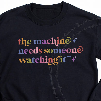 The Machine Needs Someone Watching It Care & Resist Gildan crewneck sweatshirt in Black