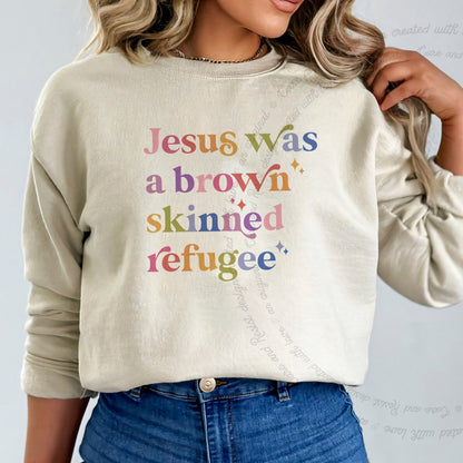 Jesus Was a Brown Skinned Refugee Care & Resist Gildan crewneck sweatshirt in Sand