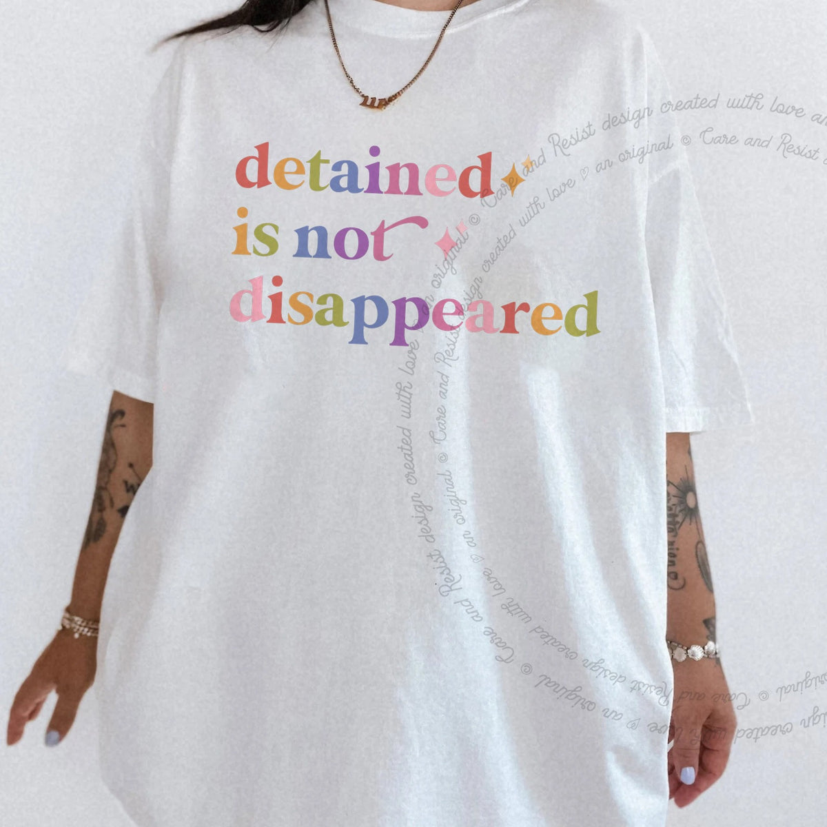 Detained is not Disappeared Care & Resist rainbow tee