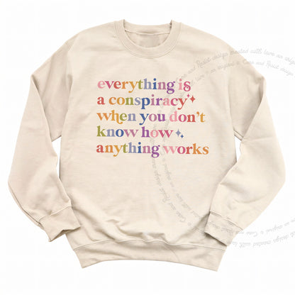 Everything Is a Conspiracy When You Don't Know How Anything Works Care & Resist Gildan crewneck sweatshirt in Sand
