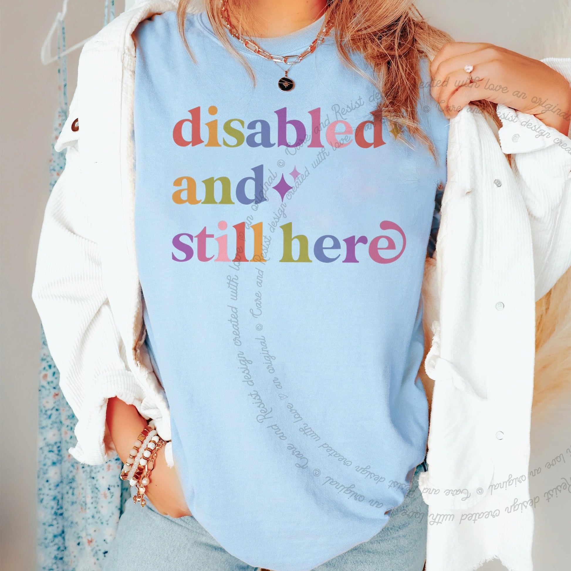 Disabled and Still Here Care & Resist rainbow Comfort Colors tee, Chambray