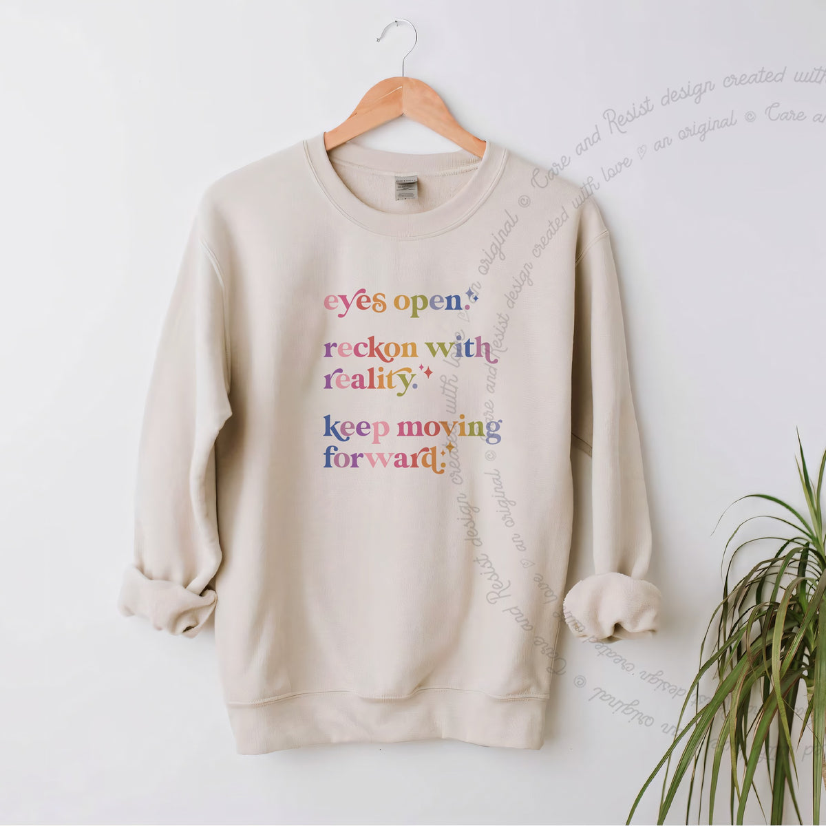 Eyes Open. Reckon With Reality. Keep Moving Forward. Care & Resist Gildan crewneck sweatshirt in Sand