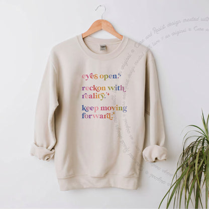 Eyes Open. Reckon With Reality. Keep Moving Forward. Care & Resist Gildan crewneck sweatshirt in Sand