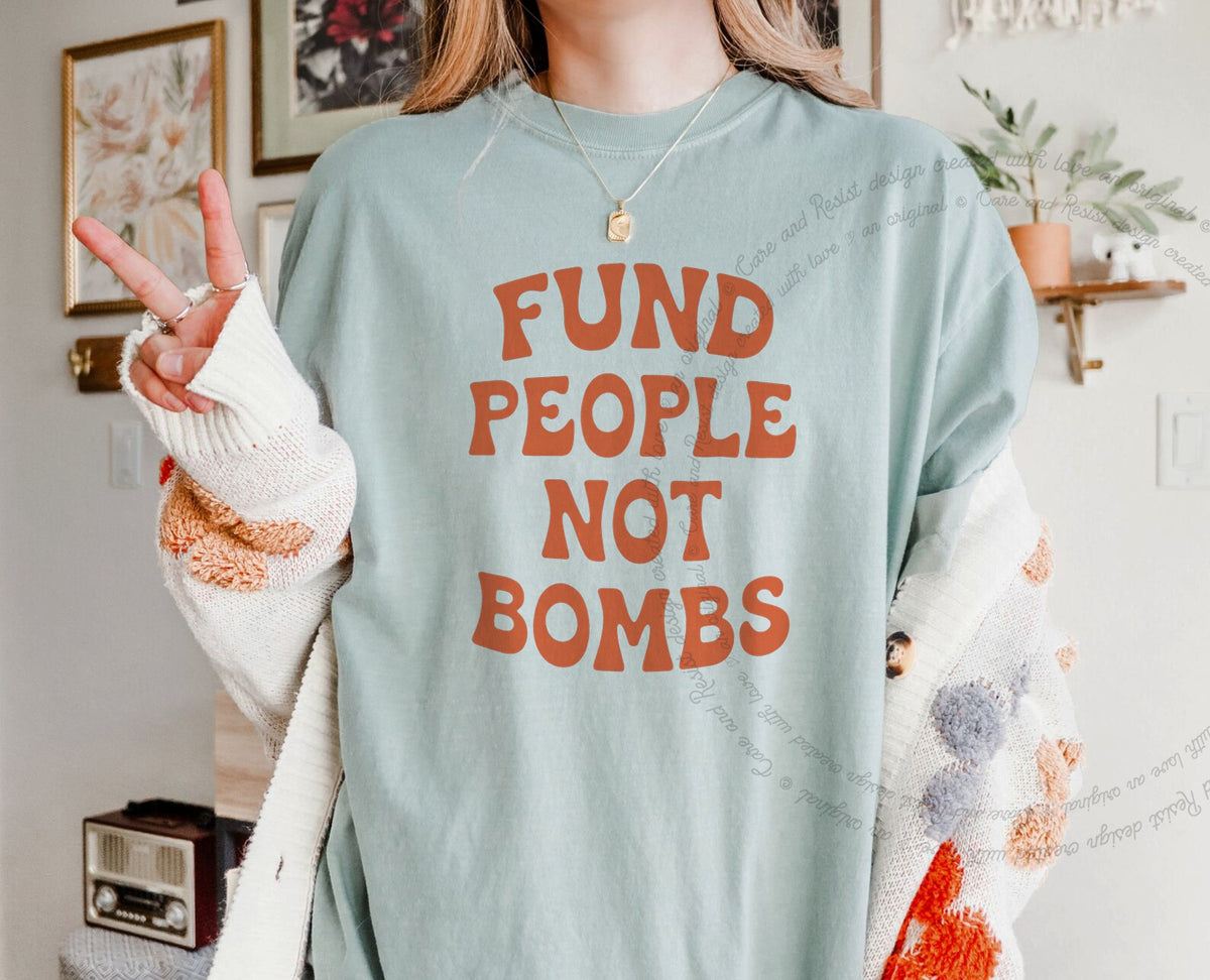 Fund People not Bombs Stacked Care & Resist progressive t-shirt in Bay