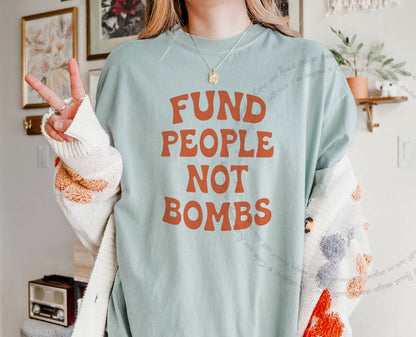Fund People not Bombs Stacked Care & Resist progressive t-shirt in Bay